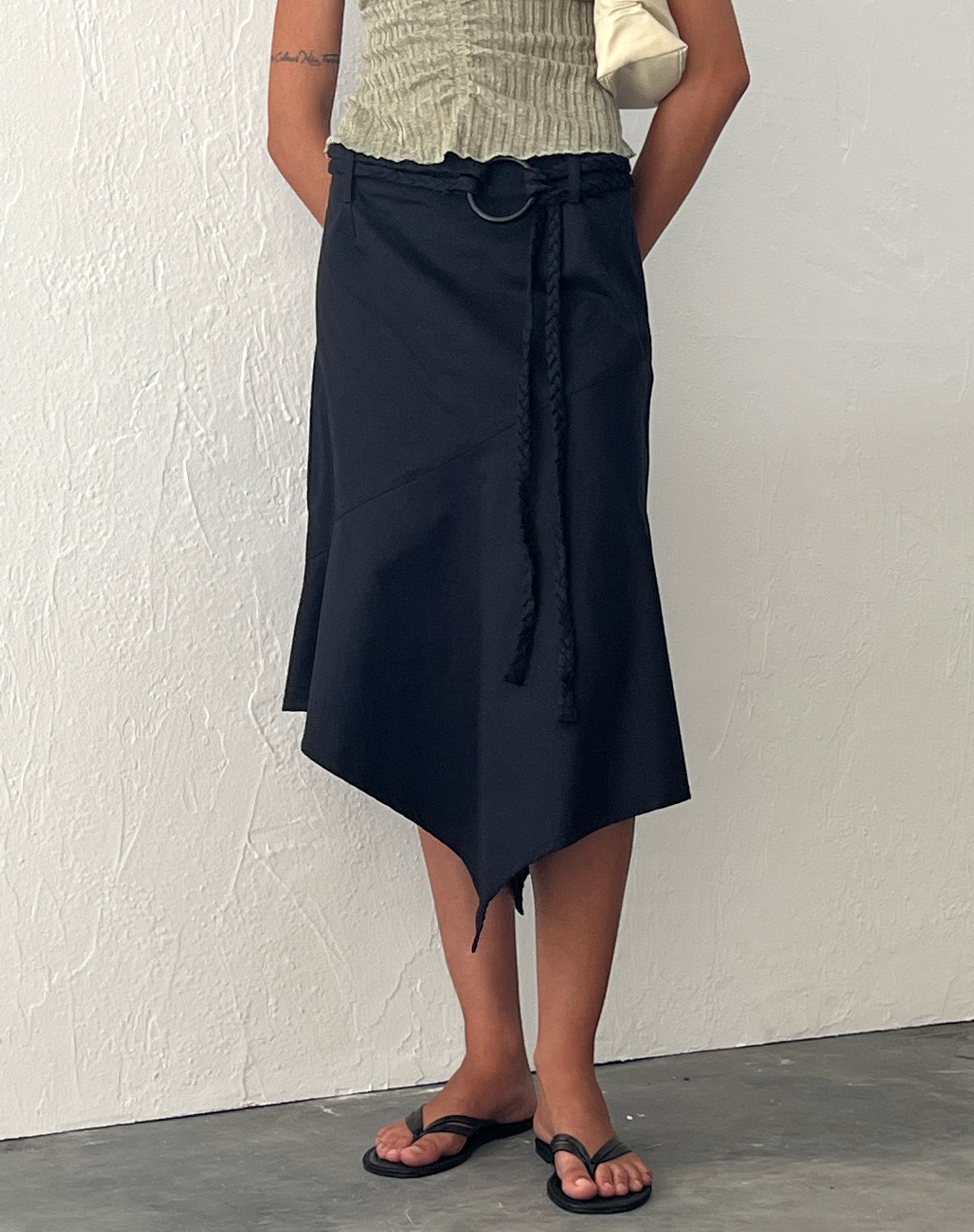 Image of Nejusi Asymmetric Midi Skirt in Black with Braided Belt (Jupe midi asymétrique en noir avec ceinture tressée)