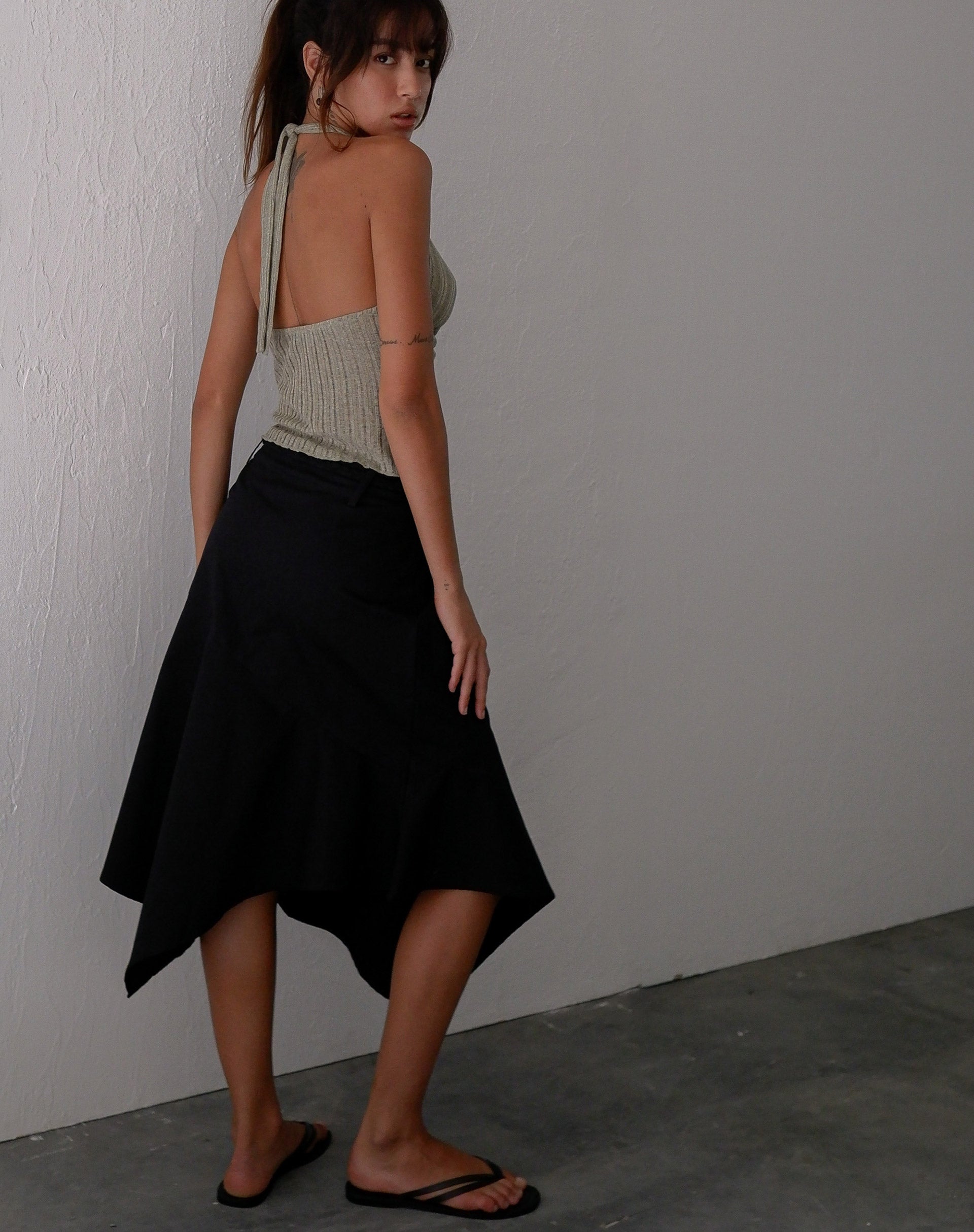 Image of Nejusi Asymmetric Midi Skirt in Black with Braided Belt (Jupe midi asymétrique en noir avec ceinture tressée)